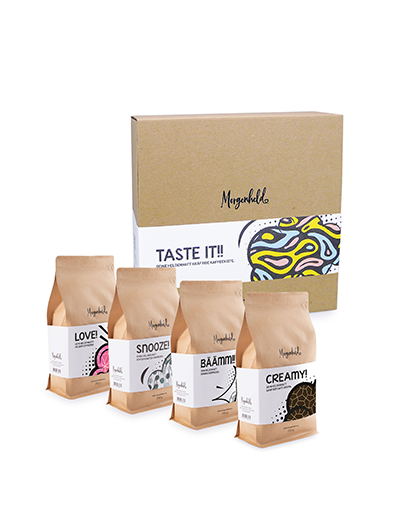 Vierer‑Kaffeegeschenkset „TASTE IT!“ von Morgenheld mit vier 250‑g‑Röstungen in dekorativer Verpackung.